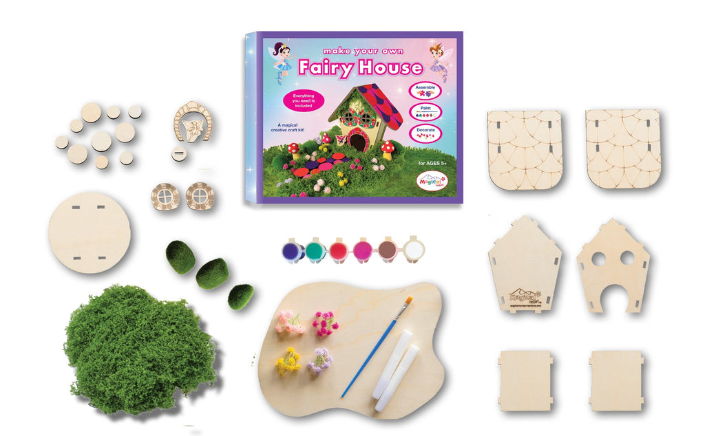 DIY wooden fairy house craft kit contents laid out, including wood pieces, moss, flowers, paint, and brush.