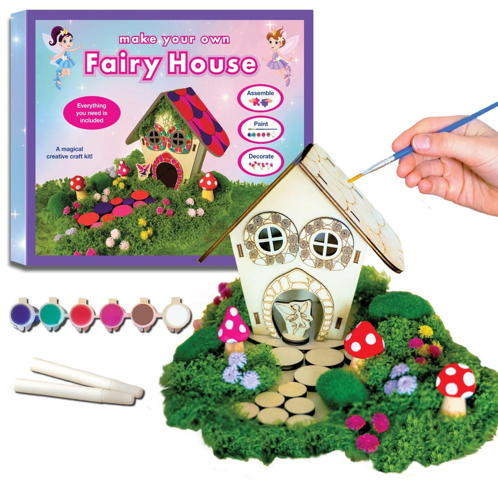 DIY wooden fairy house craft kit with paints, brush, moss, flowers, mushrooms, glue and base shown with box.