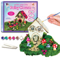 DIY wooden fairy house craft kit with paints, brush, moss, flowers, mushrooms, glue and base shown with box.