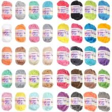 Assortment of 40 colorful acrylic yarn skeins arranged in rows on a white background.
