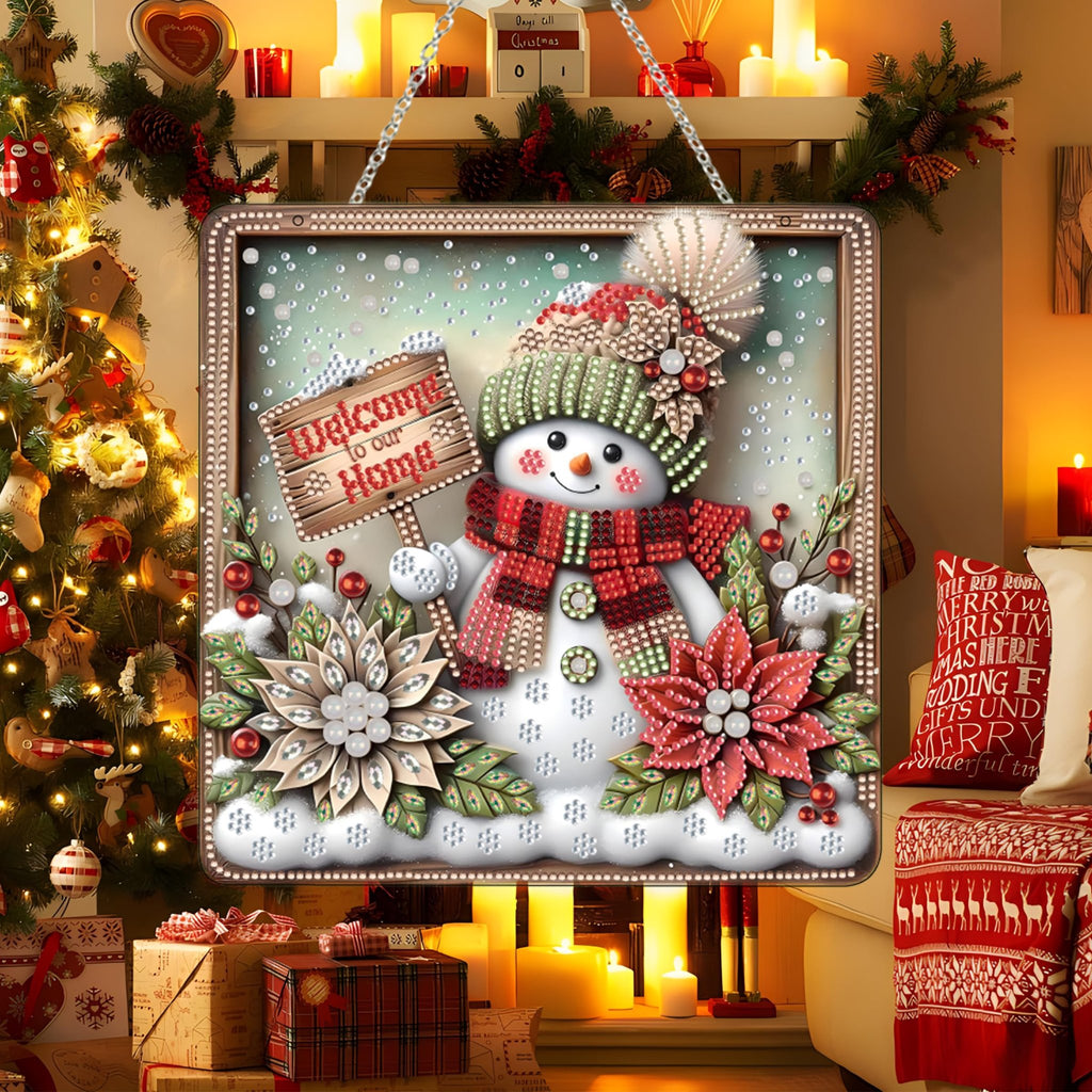 Diamond art snowman ornament kit hanging in a festive Christmas scene with a tree and fireplace.