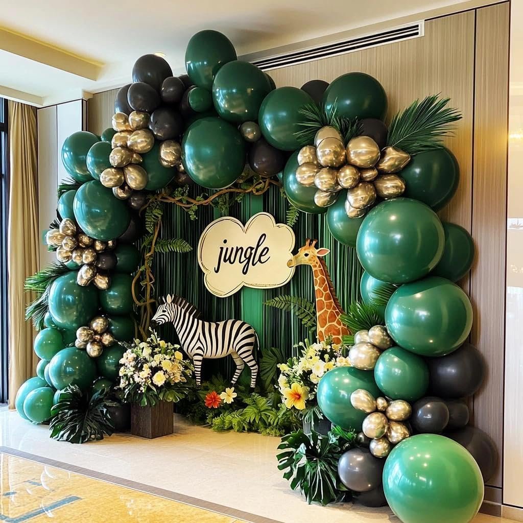 Jungle-themed balloon arch with dark green, black, and metallic gold balloons, featuring a zebra and giraffe cutout, and a 'jungle' sign.