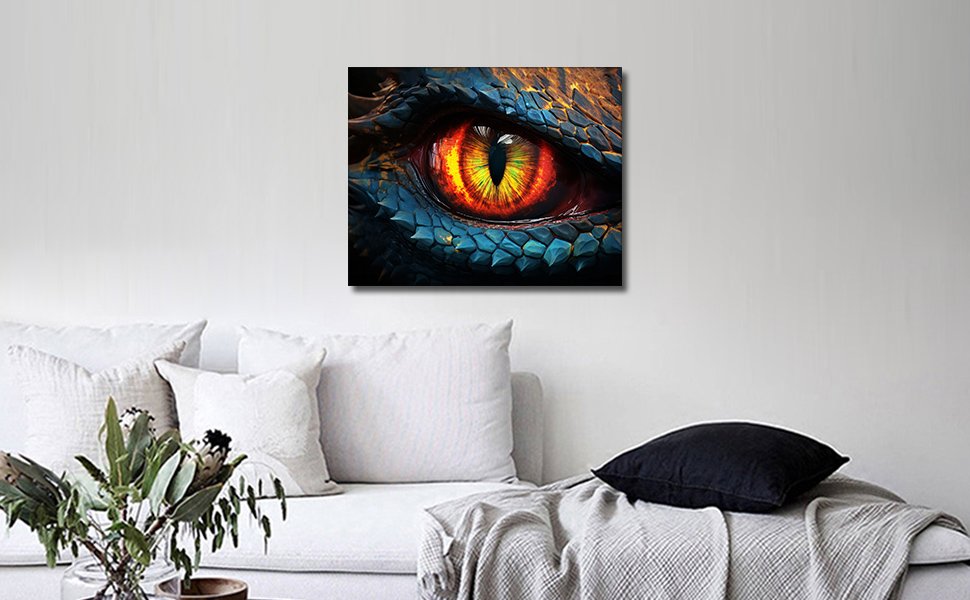 Close-up of a dragon's eye with vibrant orange and yellow iris, set against blue scales, displayed on a wall above a sofa.