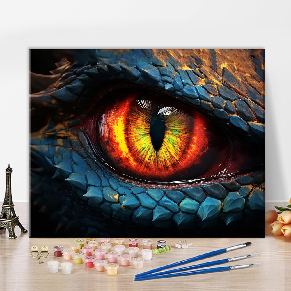 Dragon eye paint by numbers kit with acrylic paints and brushes on a wooden surface, close-up view.