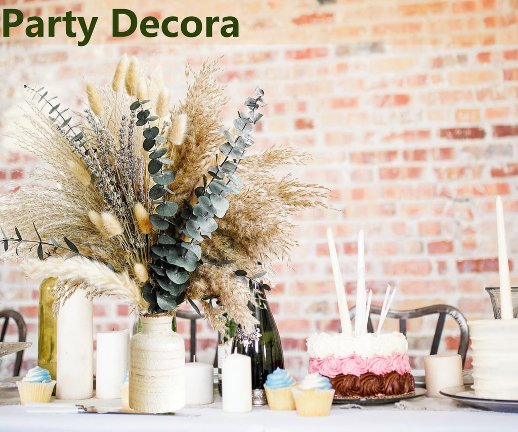 Boho dried flower bouquet with pampas grass and eucalyptus on a table with cupcakes and cakes
