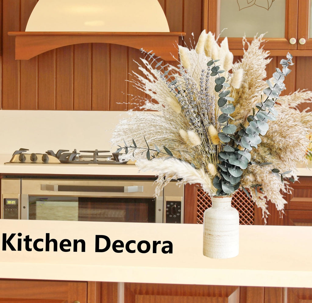 Dried boho flower bouquet with pampas grass, lavender, and eucalyptus in a textured vase on a kitchen counter.