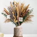 Dried flower bouquet with pampas grass, lavender, eucalyptus, and cotton in a decorative vase.