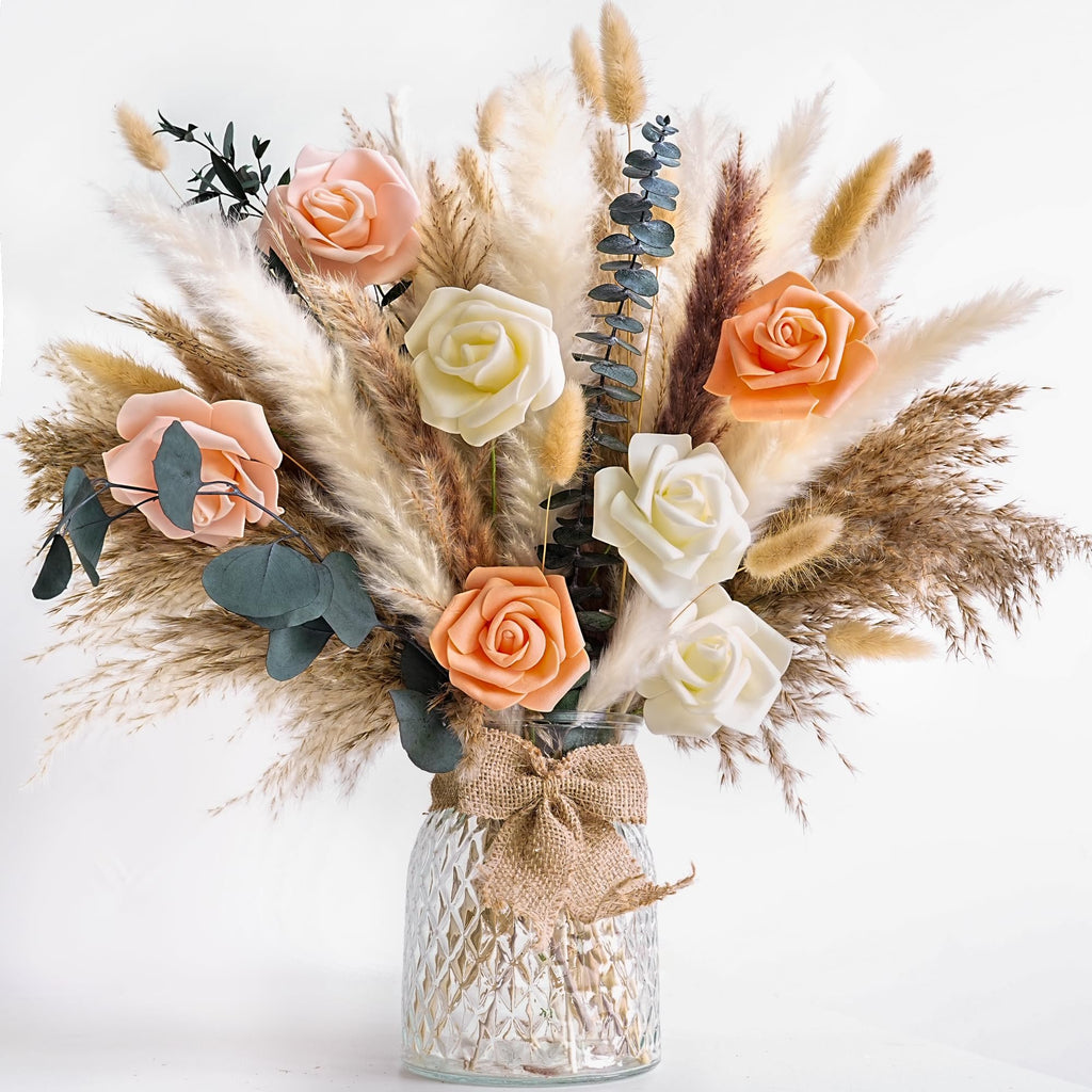 Dried flower bouquet with pampas grass and roses in a textured glass vase with burlap bow