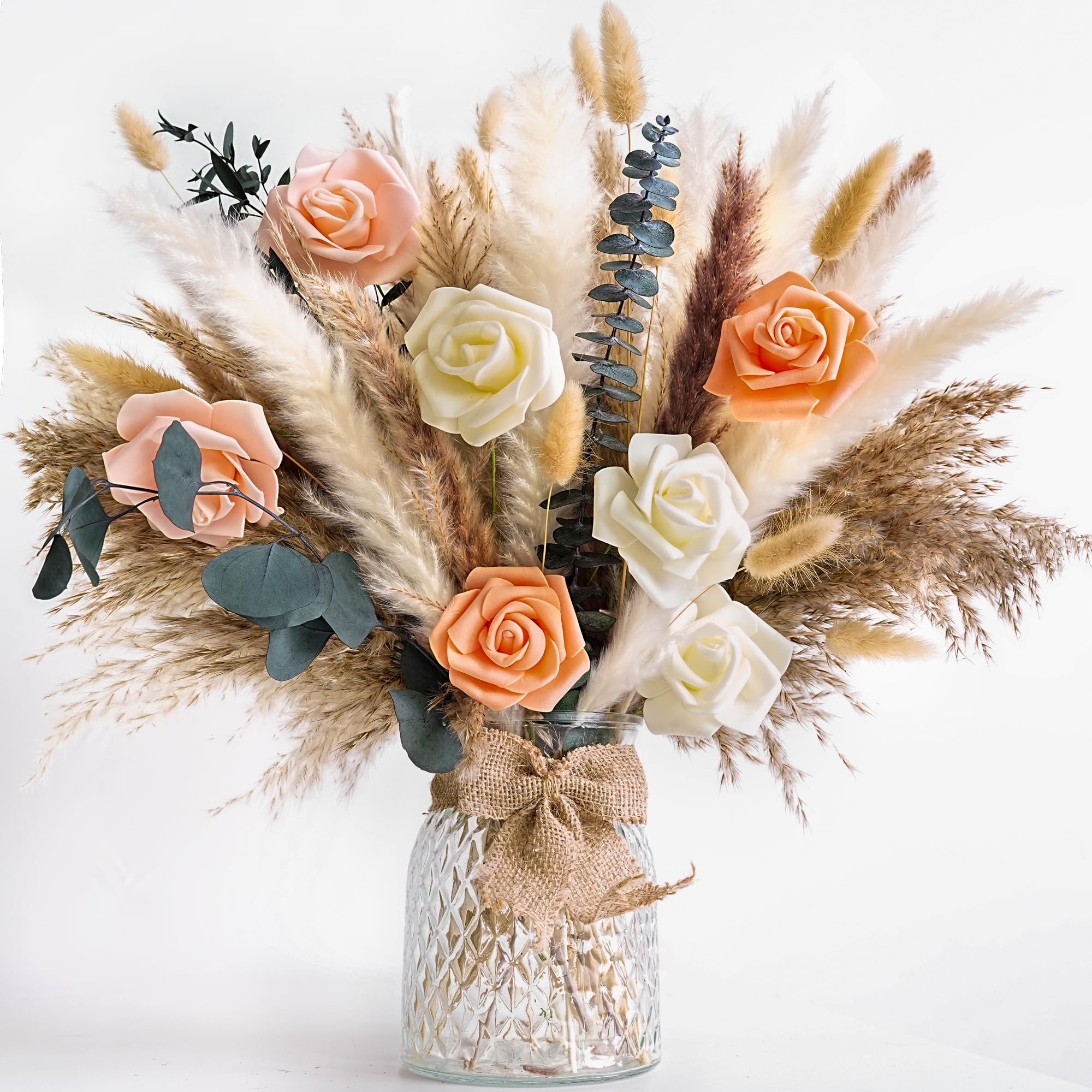 Dried flower bouquet with pampas grass and roses in a textured glass vase with burlap bow