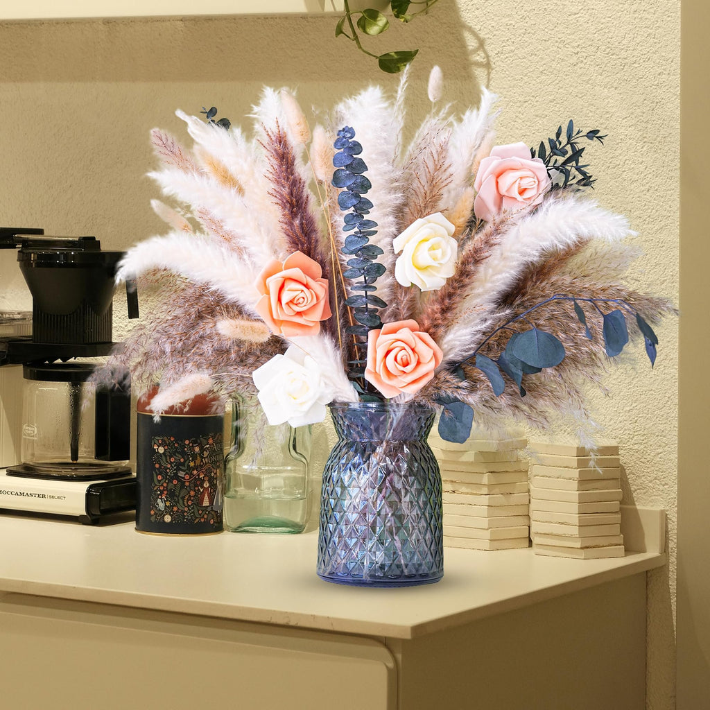 Dried flower bouquet with pampas grass and roses in a blue vase on a shelf