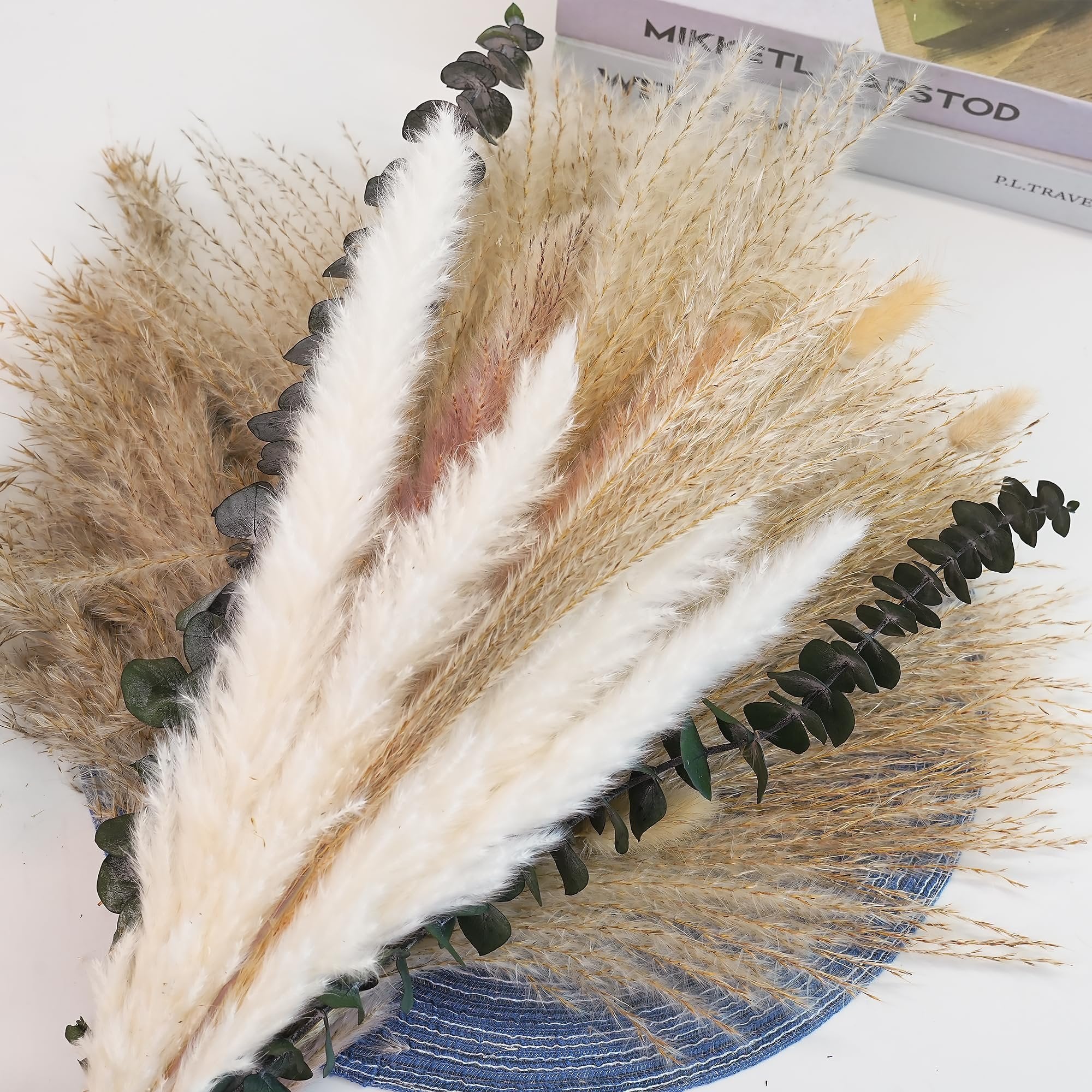 Dried pampas grass and bunny tail bouquet with eucalyptus on a blue textured mat