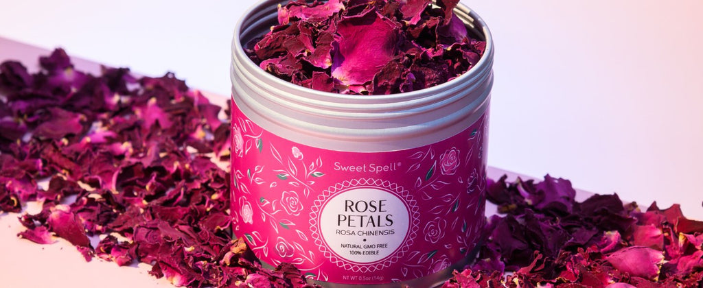 Can of dried rose petals with petals scattered around it on a surface.