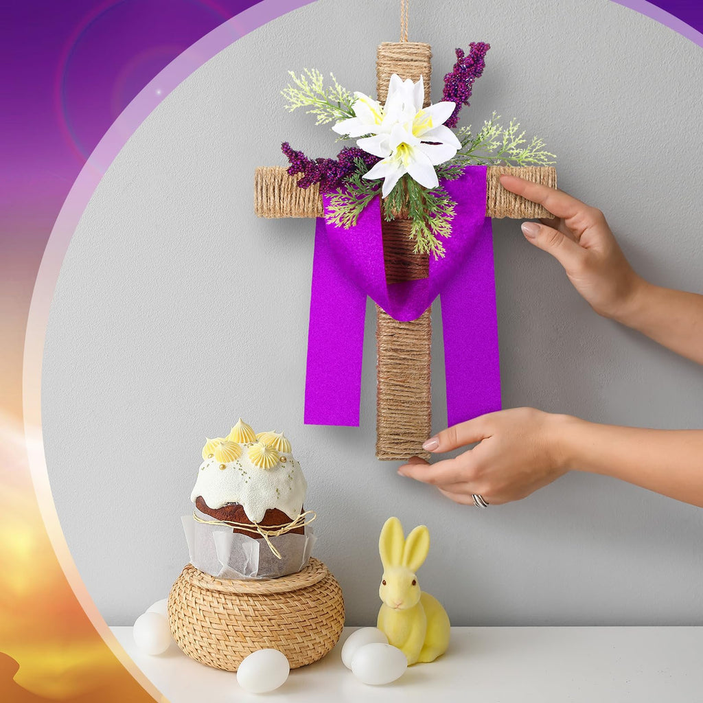 Easter cross wreath with artificial lilies and purple ribbon, displayed with a cake and bunny decor