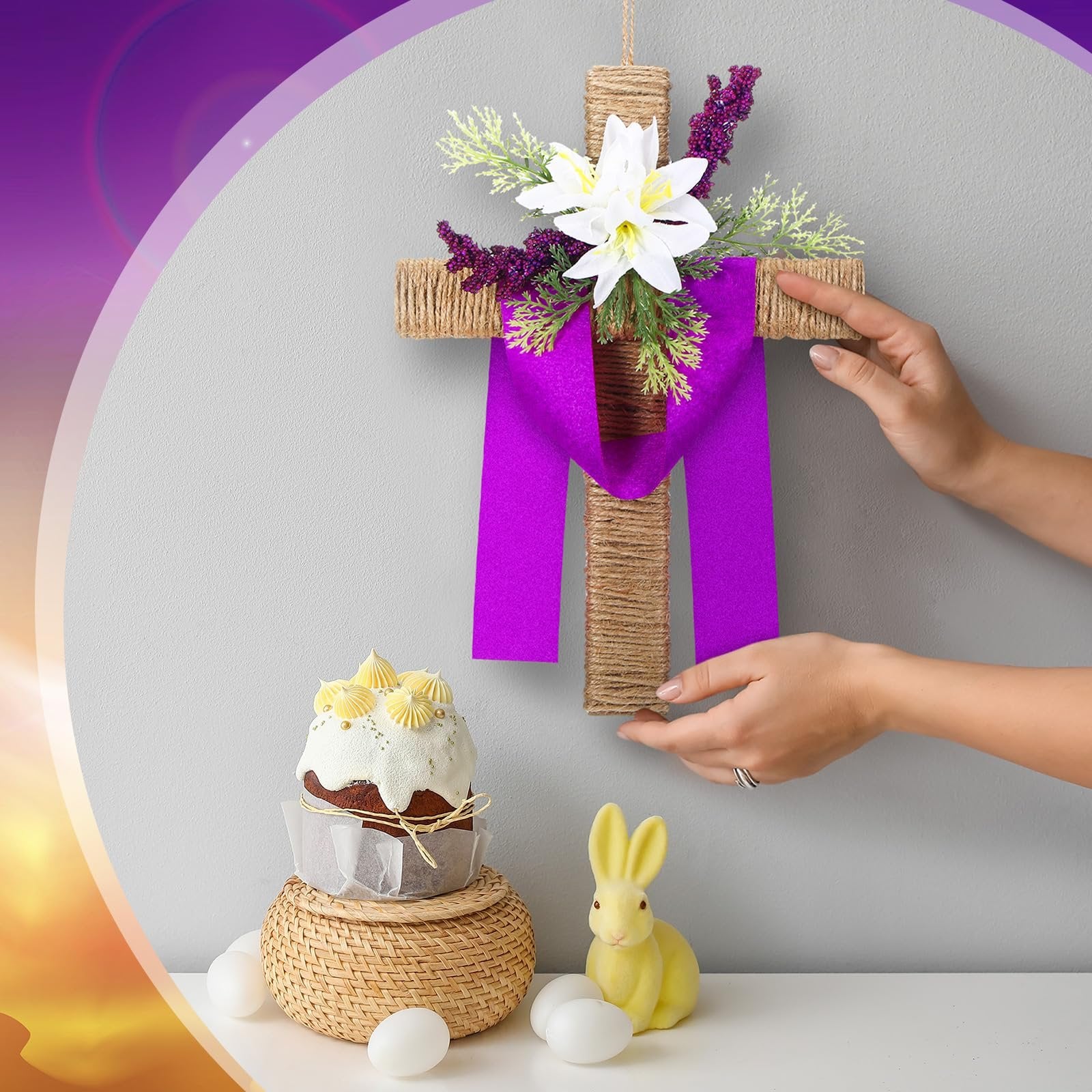 Easter cross wreath with artificial lilies and purple ribbon, displayed with a cake and bunny decor
