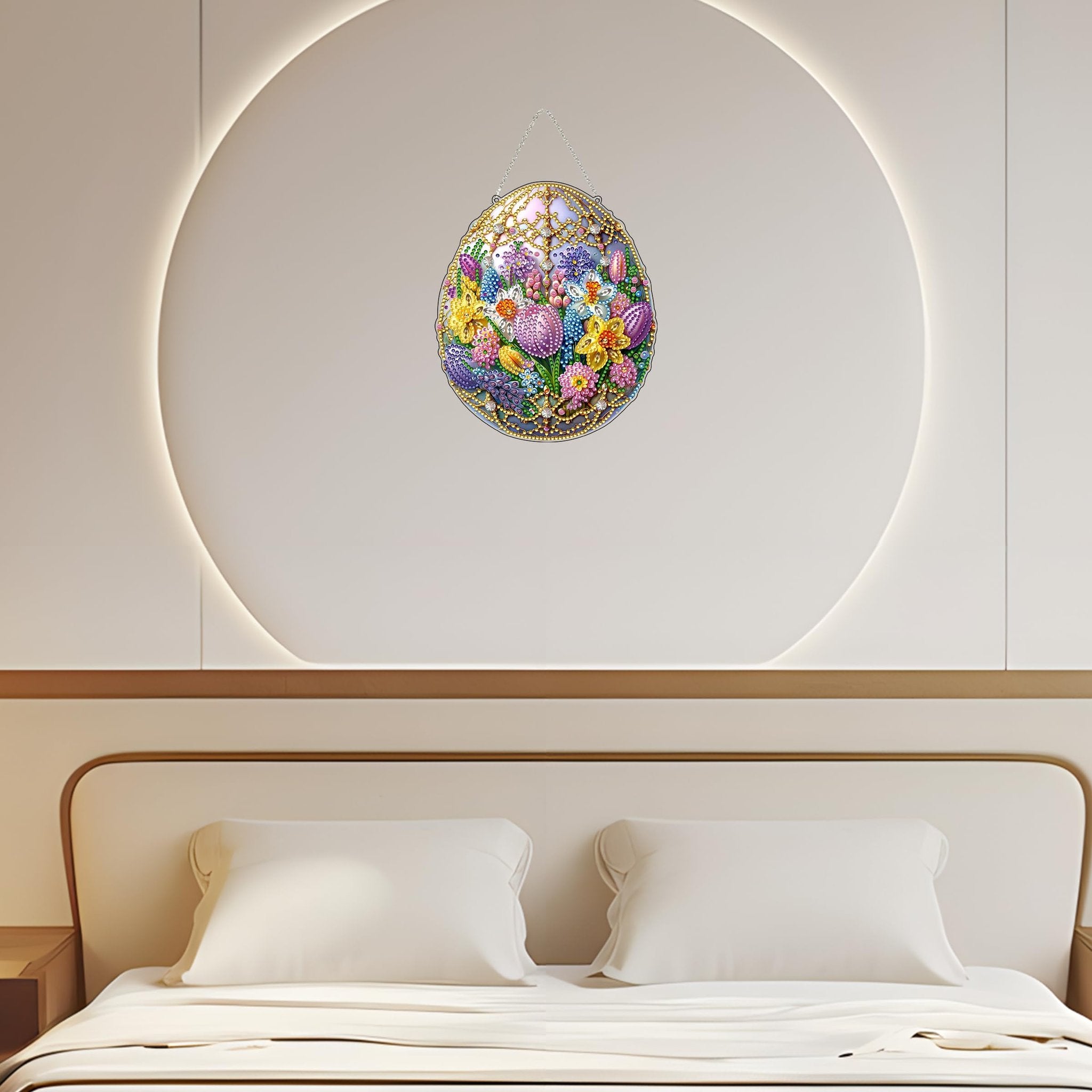Easter egg diamond art hanging decoration with floral design, displayed on a wall above a bed.