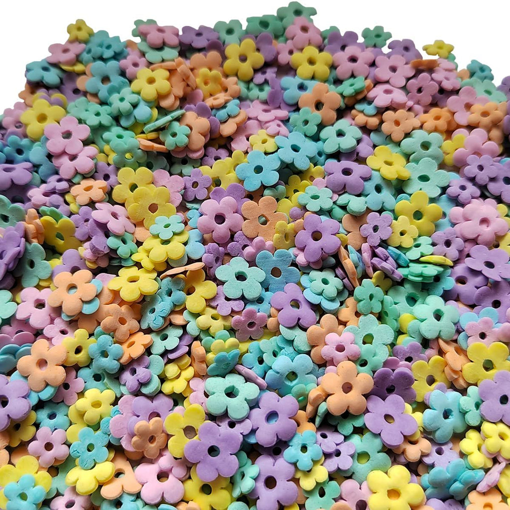 Pile of edible pastel flower-shaped sprinkles for cake and dessert decoration