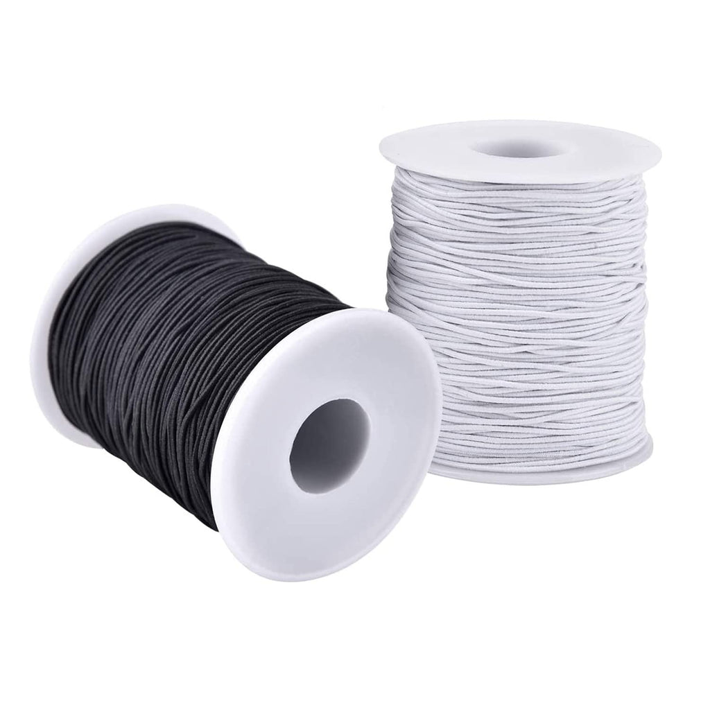 Two spools of elastic string, one black and one white, on white plastic spools against a white background.