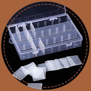 Clear plastic organizer box with 24 compartments and small plastic bags for embroidery floss