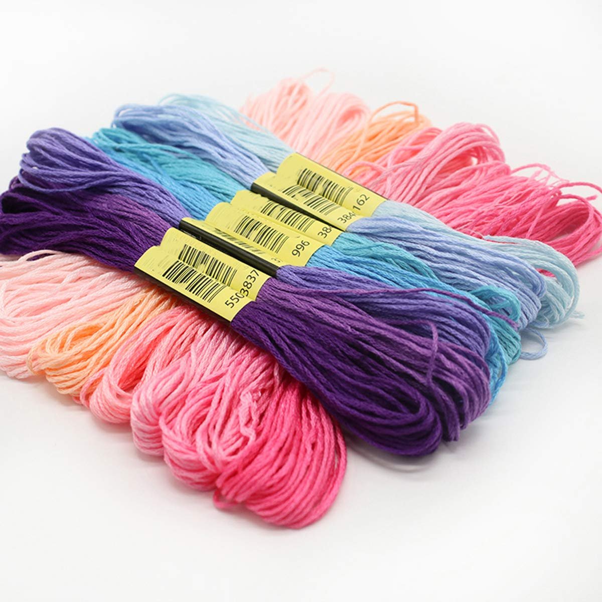 Embroidery floss in rainbow colors fanned out, with yellow tags showing barcodes and numbers.