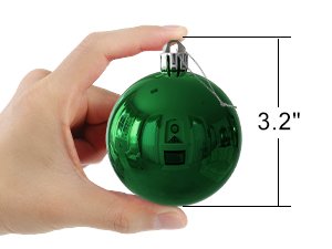 Hand holding a single emerald green shatterproof Christmas ball ornament with a size indicator showing 3.2 inches.