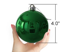 Hand holding a shiny emerald green Christmas ornament with a 4.0 inch measurement overlay
