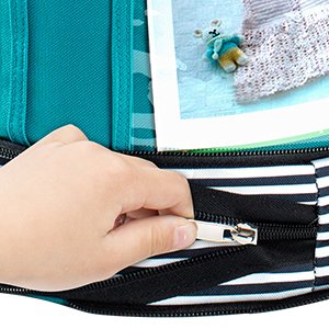 Hand zipping up a black and white striped expandable yarn storage organizer tote bag, showing teal interior pockets and a small knitted bunny.