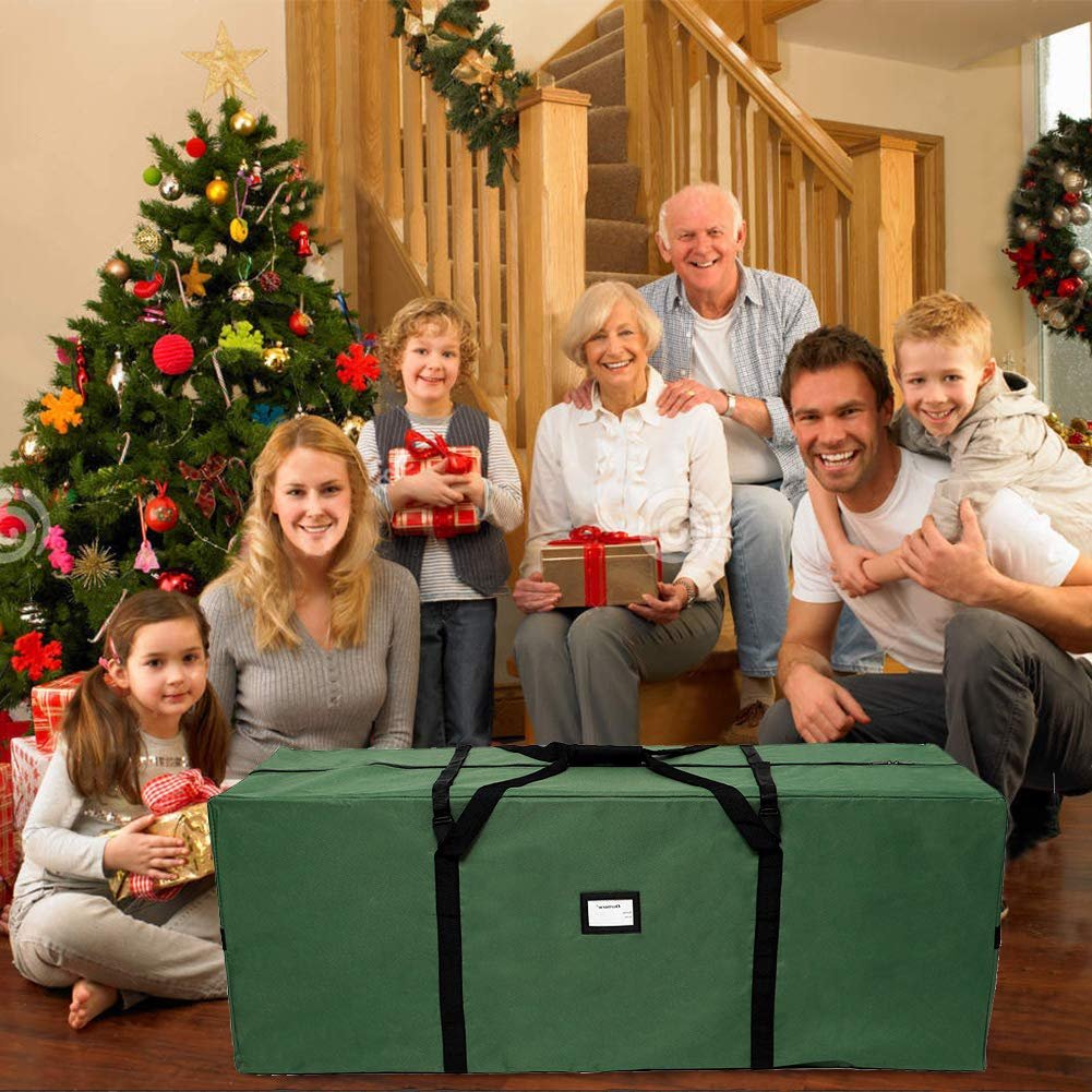 Green Christmas tree storage bag in front of a family and decorated Christmas tree on stairs