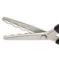 Close-up of stainless steel pinking shears with scalloped blades and black handles on a white background.
