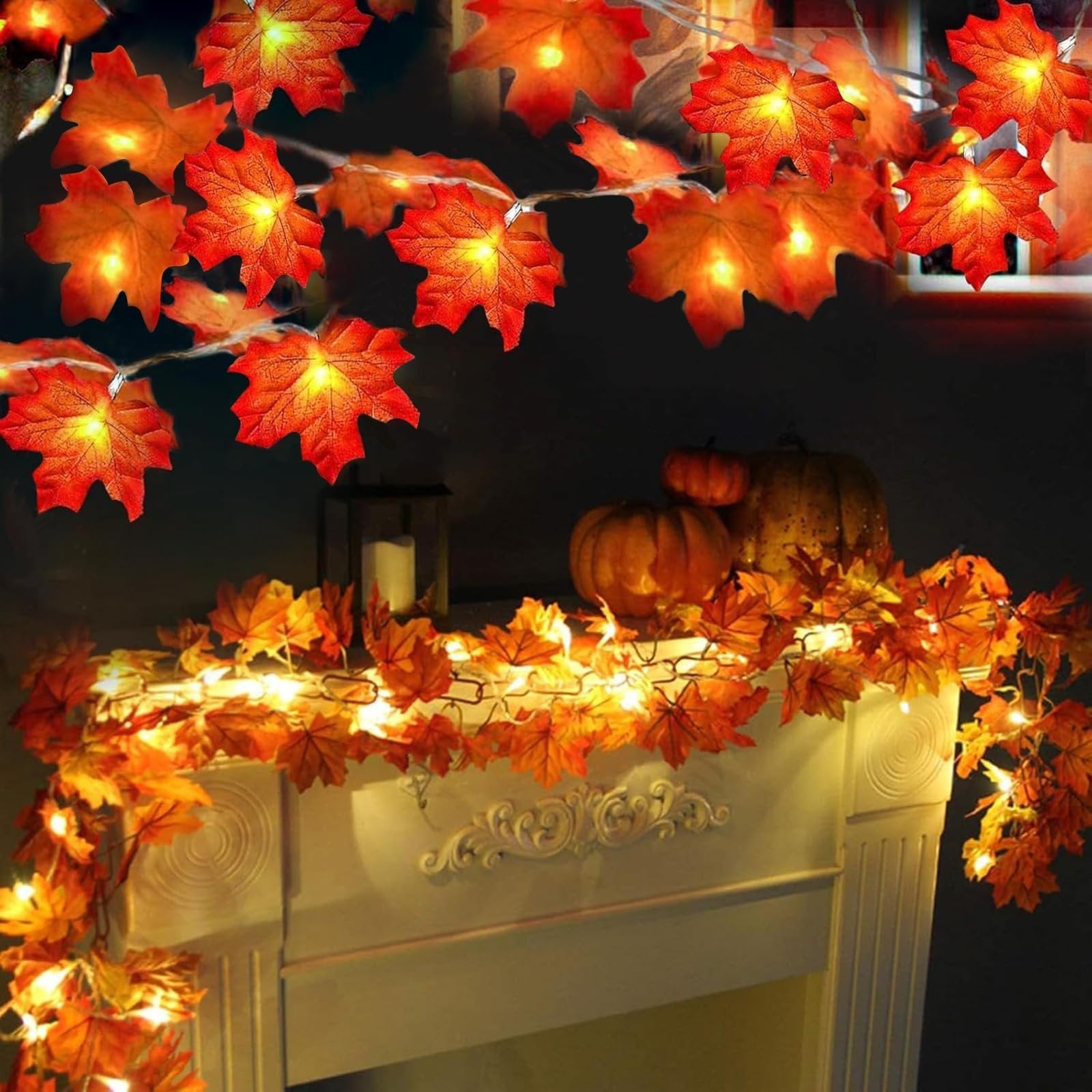 Autumn maple leaf string lights draped over a fireplace mantel with pumpkins and a candle lantern.