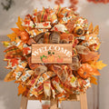 Fall mesh wreath with pumpkins, leaves, and a wooden sign that says WELCOME.