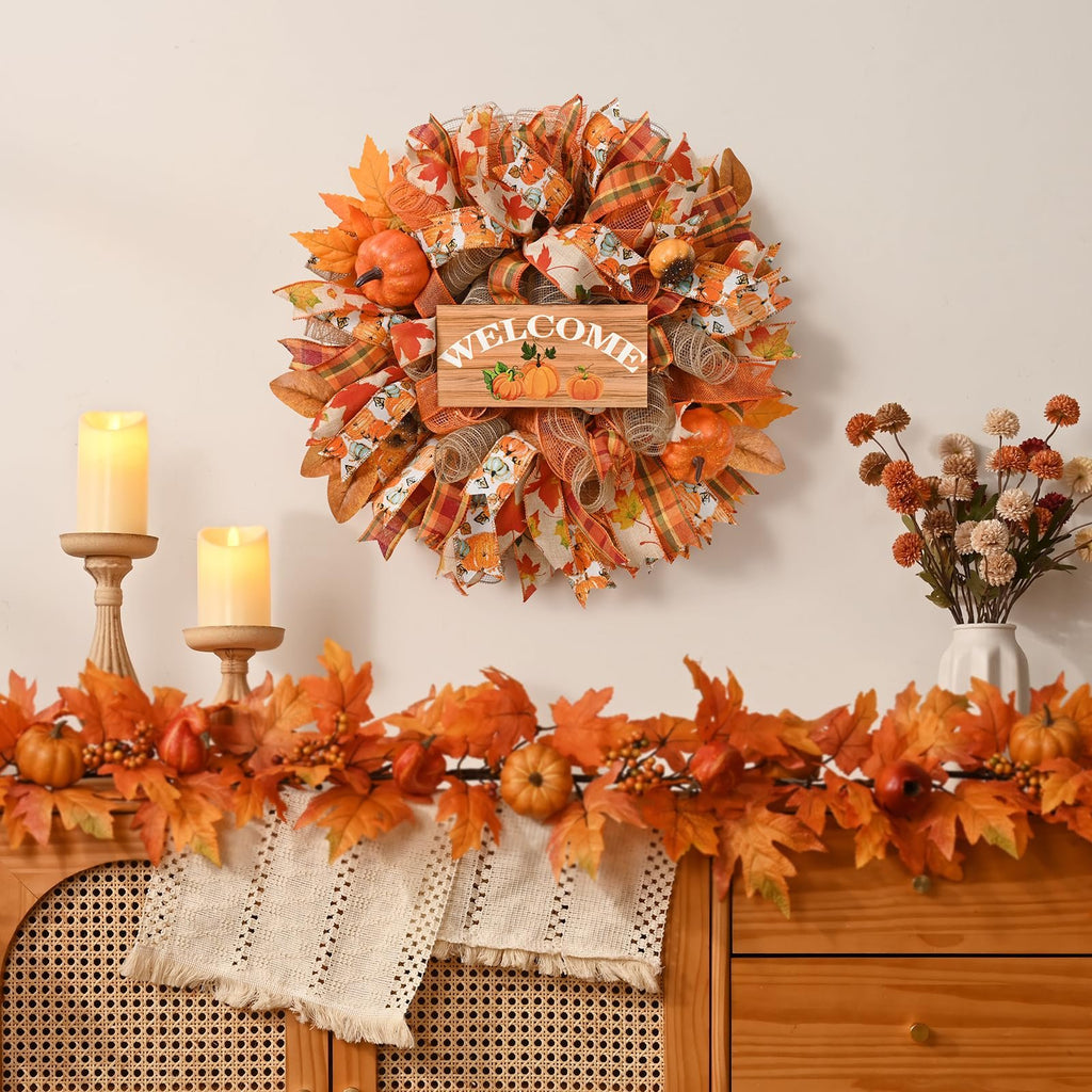 Fall mesh wreath with wooden welcome sign and pumpkins, decorated with autumn leaves and plaid ribbons.