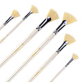 Set of six fan paint brushes with natural bristles and light wood handles, angled view on white background.