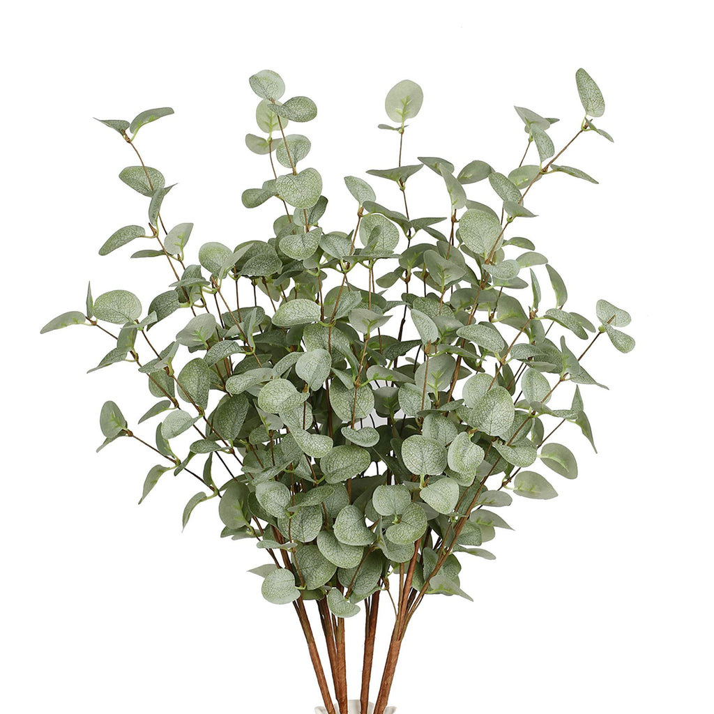 Faux eucalyptus stems with light green leaves and brown stems, presented against a white background.