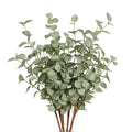 Faux eucalyptus stems with light green leaves and brown stems, presented against a white background.