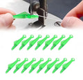 Hands using a green fish mouth sewing needle threader tool with a sewing machine and thread. Below are rows of green threader tools.