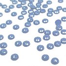 Close-up of scattered blue diamond painting drills on a white background.