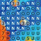 Close-up of a grid of letters and numbers on a blue background, possibly part of a craft kit or game.