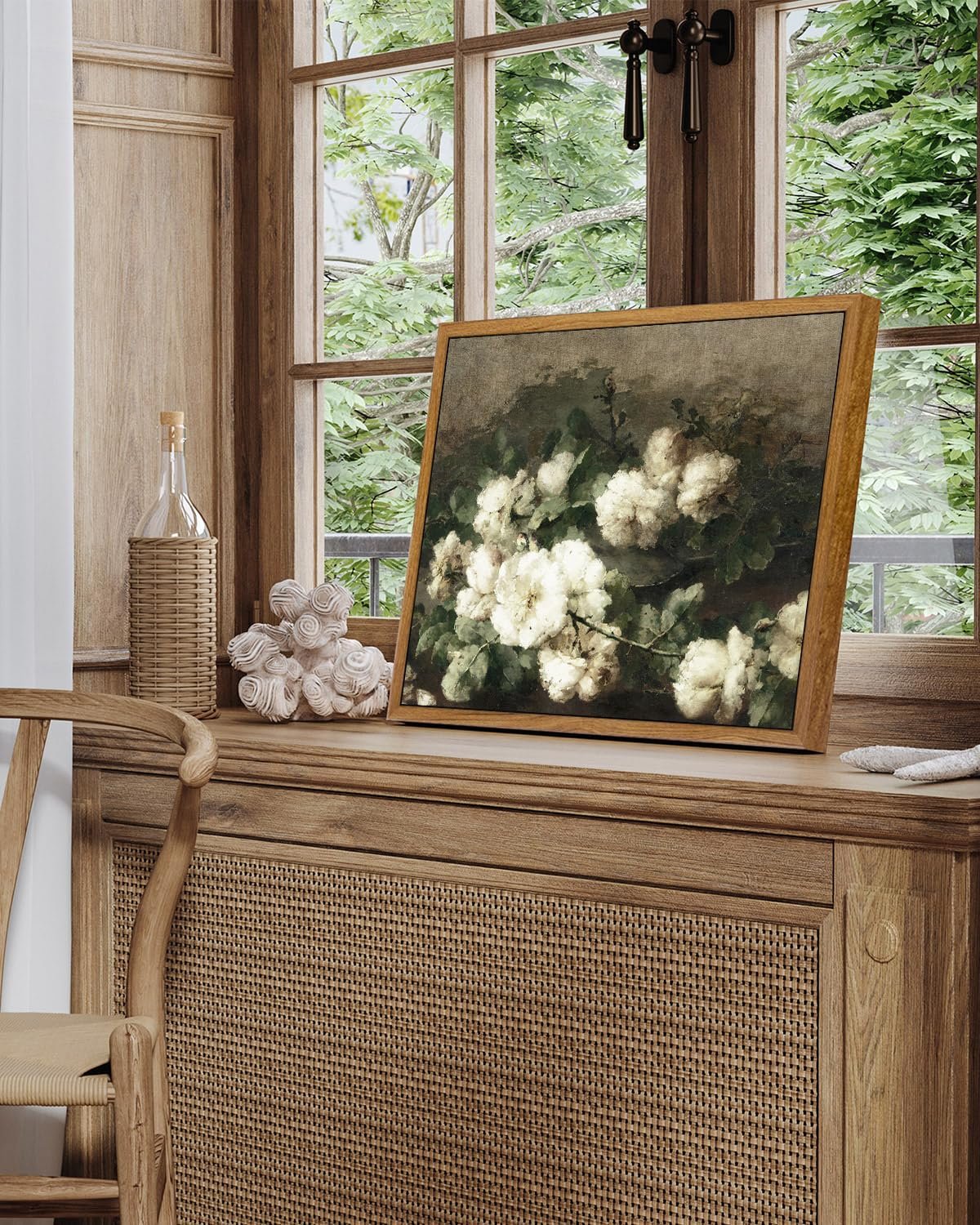 Framed vintage botanical flower print displayed on a wooden shelf by a window.