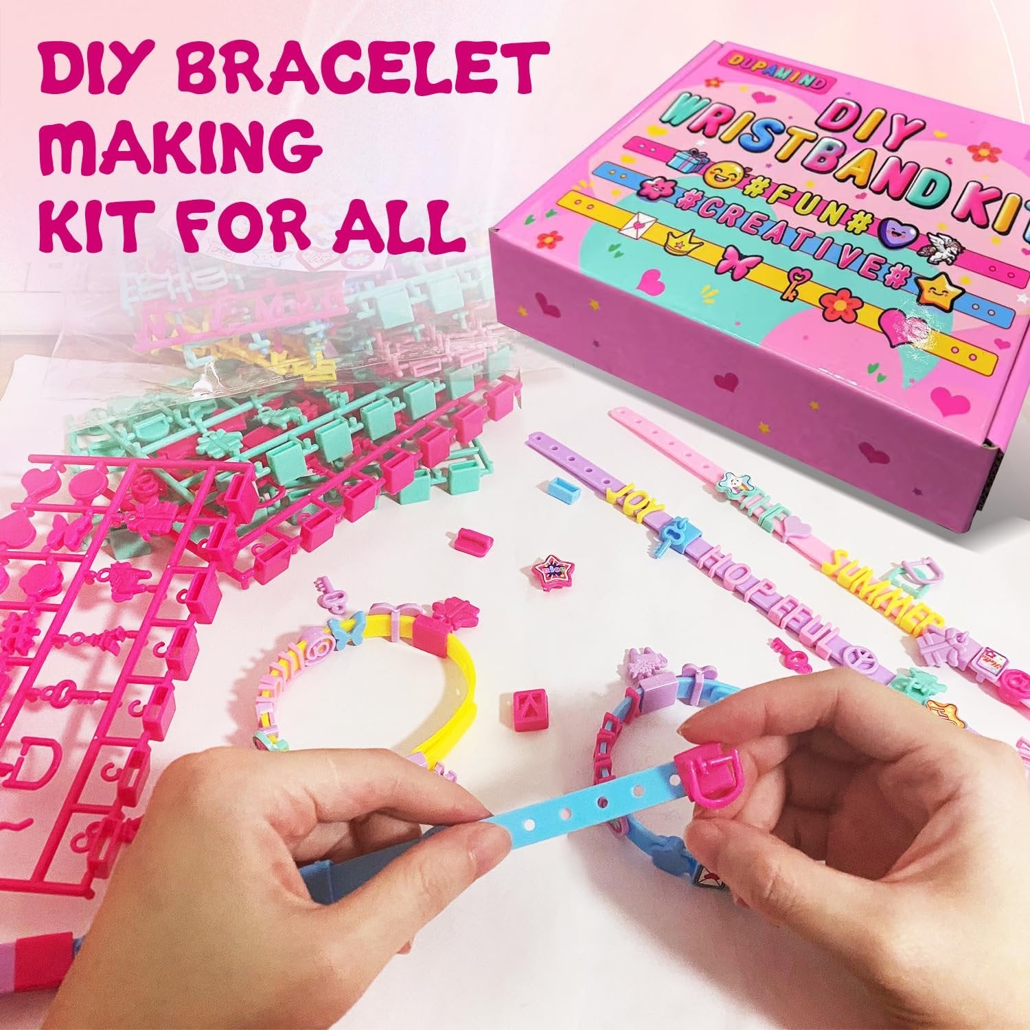 Hands assembling a DIY bracelet making kit with colorful beads, letter charms, and straps.