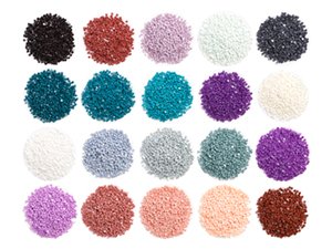 Twenty small piles of colorful diamond painting rhinestones arranged in rows on a white background.