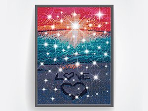 Framed diamond painting kit showing a beach sunset scene with stars and the word LOVE on the sand.
