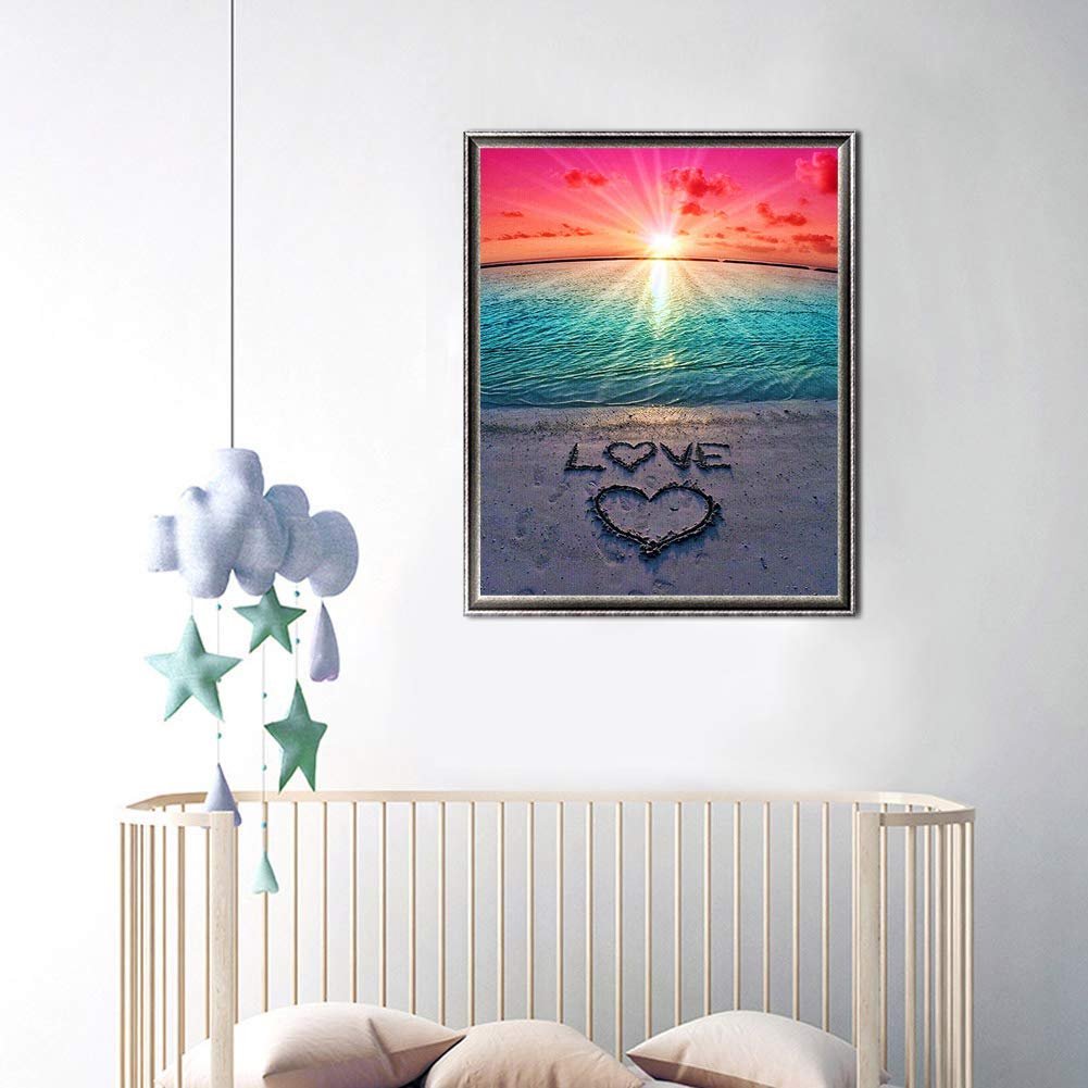 Diamond painting kit showing a beach sunset with the word LOVE and a heart drawn in the sand.
