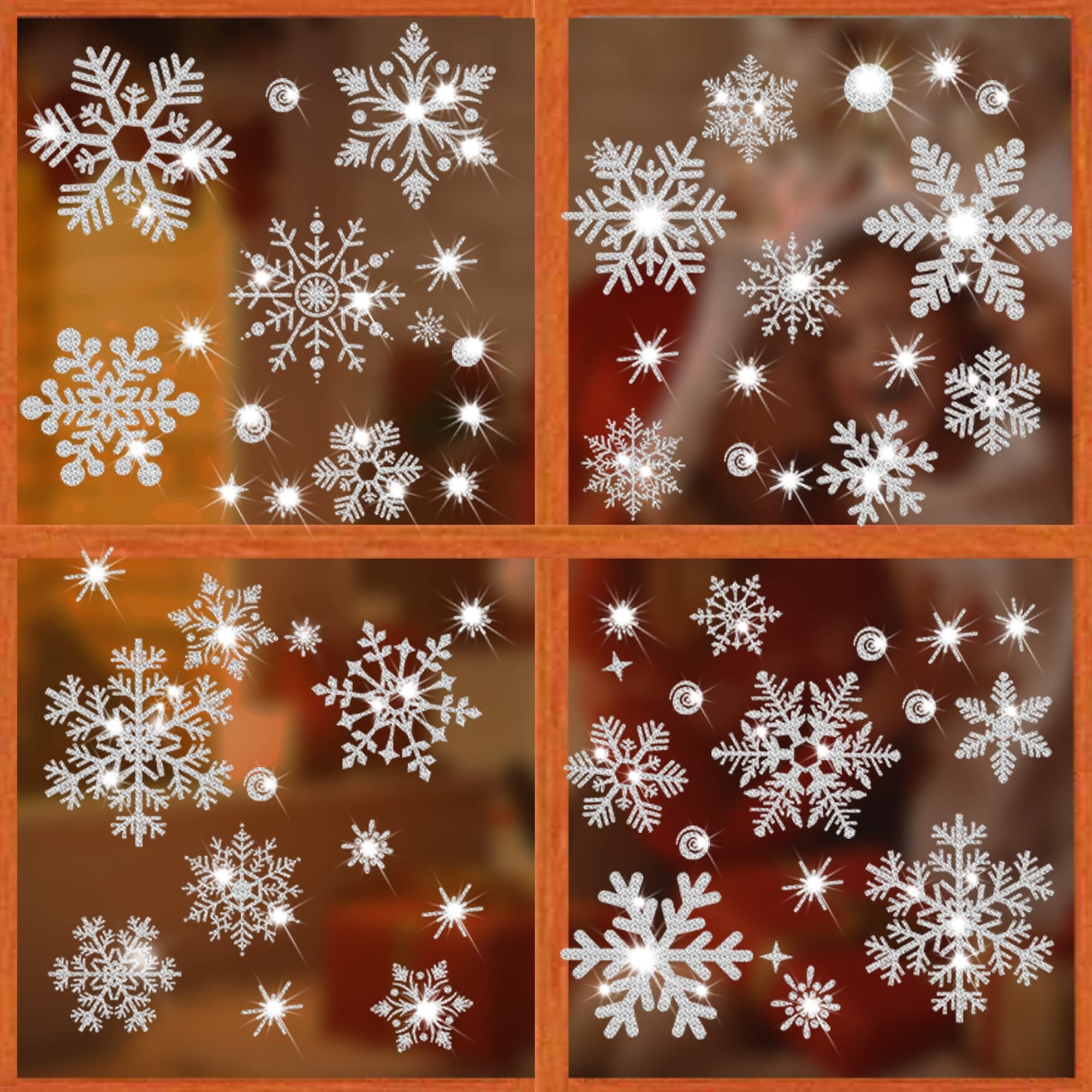 Glitter snowflake window clings in various sizes, applied to a window pane. Silver sparkling Christmas decorations.