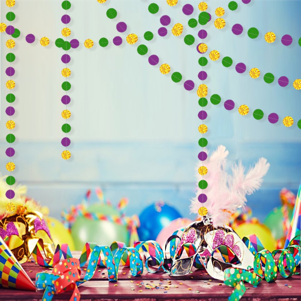 Gold, purple, and green glitter circle garlands hanging above Mardi Gras party decorations including masks, balloons, and confetti.