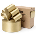 Gold satin ribbon roll with a bow on top, next to a cardboard box with brand text.