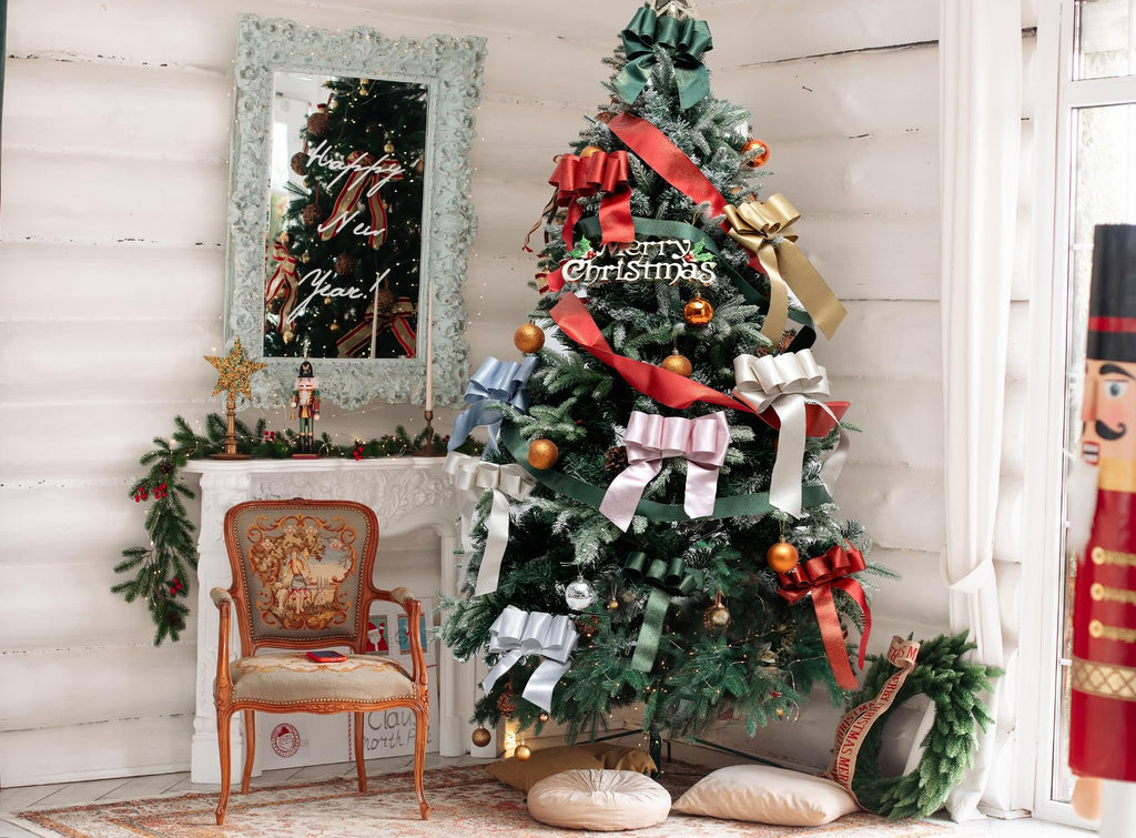 Decorated Christmas tree with various colored ribbons and ornaments, a fireplace, and a chair.