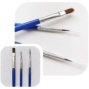 Paint brushes with blue handles and silver ferrules, close-up on white background