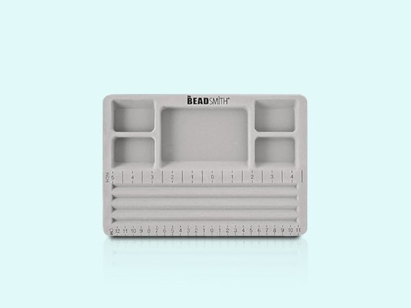 Grey flocked jewelry bead board with cover, featuring U-shaped channels and recessed compartments, with inch and centimeter rulers.