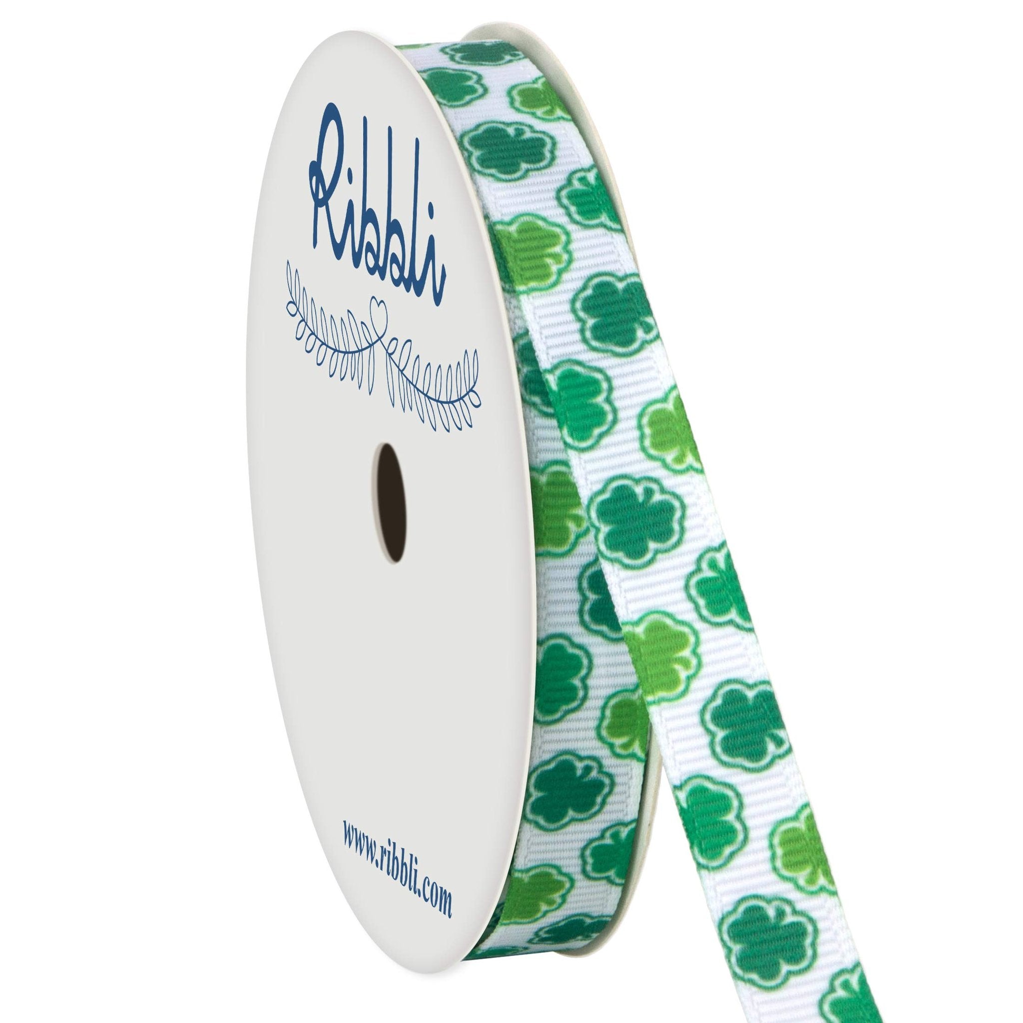 Ribbon spool with white grosgrain ribbon featuring green shamrocks and stripes, with a decorative vine graphic and website address on the spool.