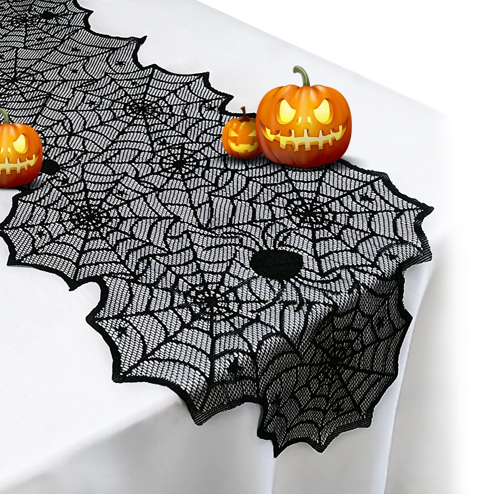 Black lace spider web table runner with decorative Halloween pumpkins on a white tablecloth